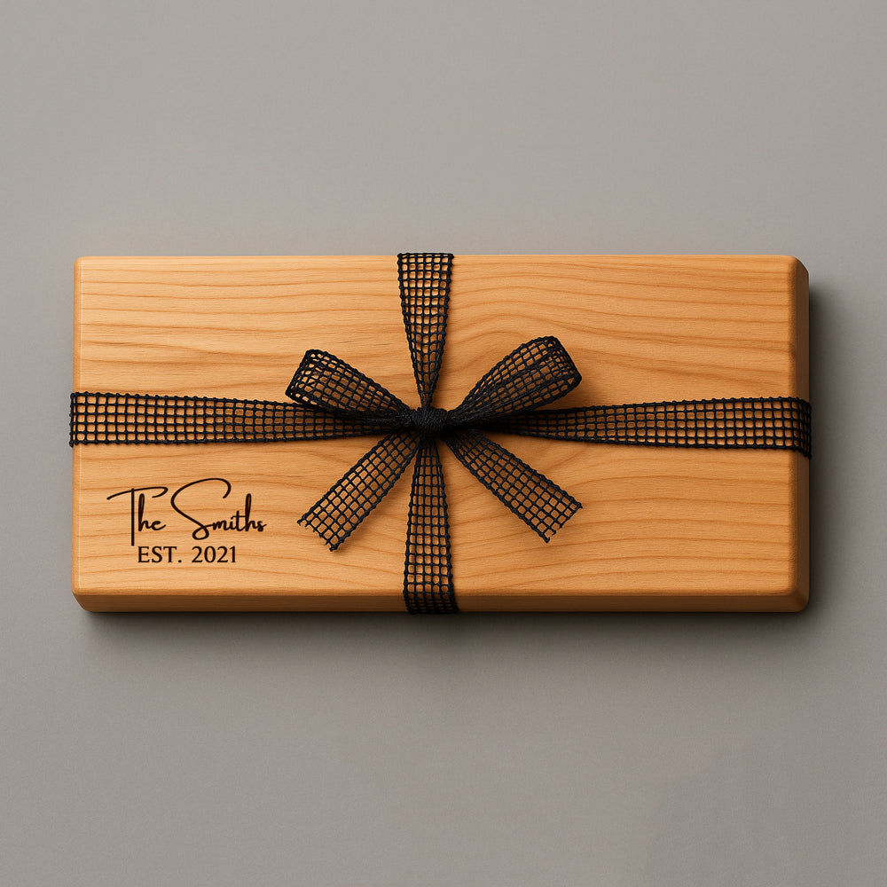 Wooden gift box with a black ribbon and 'The Smiths EST. 2021' engraving on a gray background
