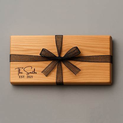 Wooden gift box with a black ribbon and 'The Smiths EST. 2021' engraving on a gray background