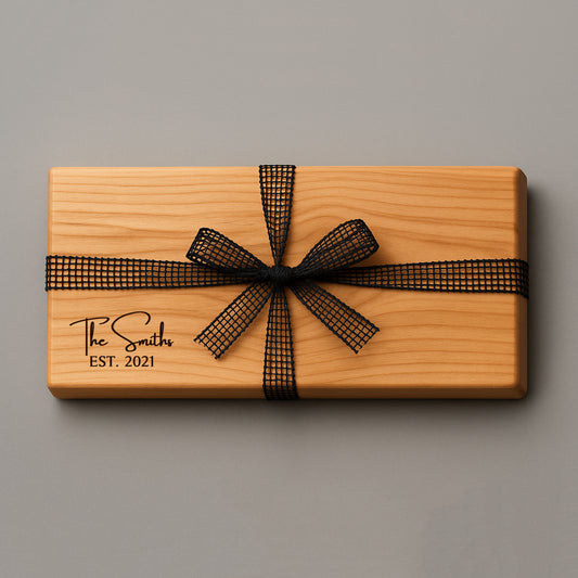 Wooden gift box with a black ribbon and 'The Smiths EST. 2021' engraving on a gray background